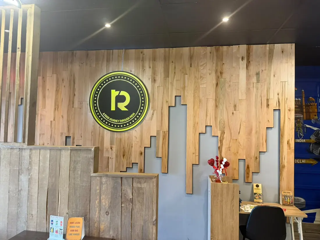 The glowing R sign at Raahi that reads A Food Journey Through India